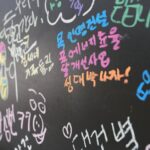 Vibrant chalk messages and drawings on a blackboard, showcasing expressive handwriting.