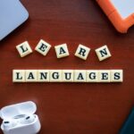Flat lay of language learning materials with gadgets promoting education.
